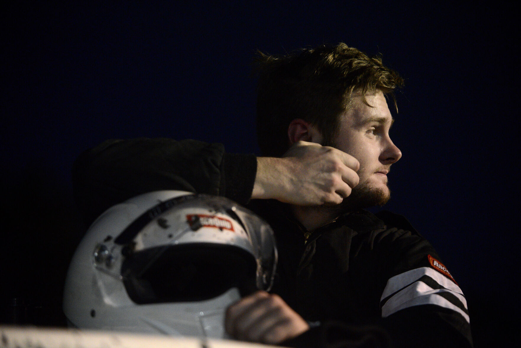 Louie Lovelace relaxes on his race car